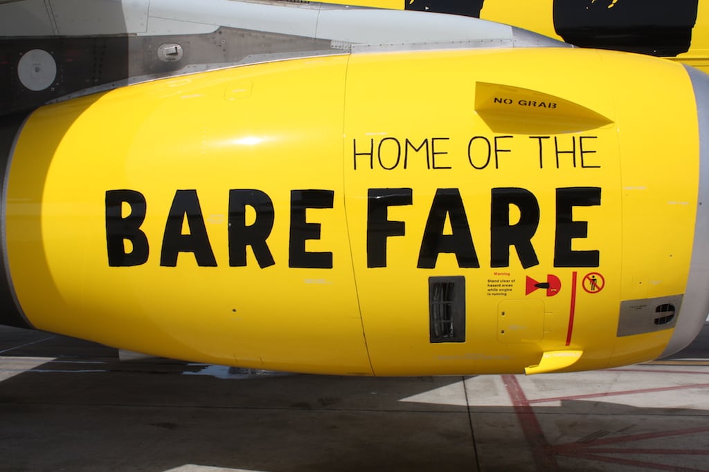 A Spirit Airlines plane with the marketing slogan on the engine.
