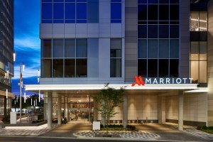 Exterior of a glass-walled hotel in the late evening