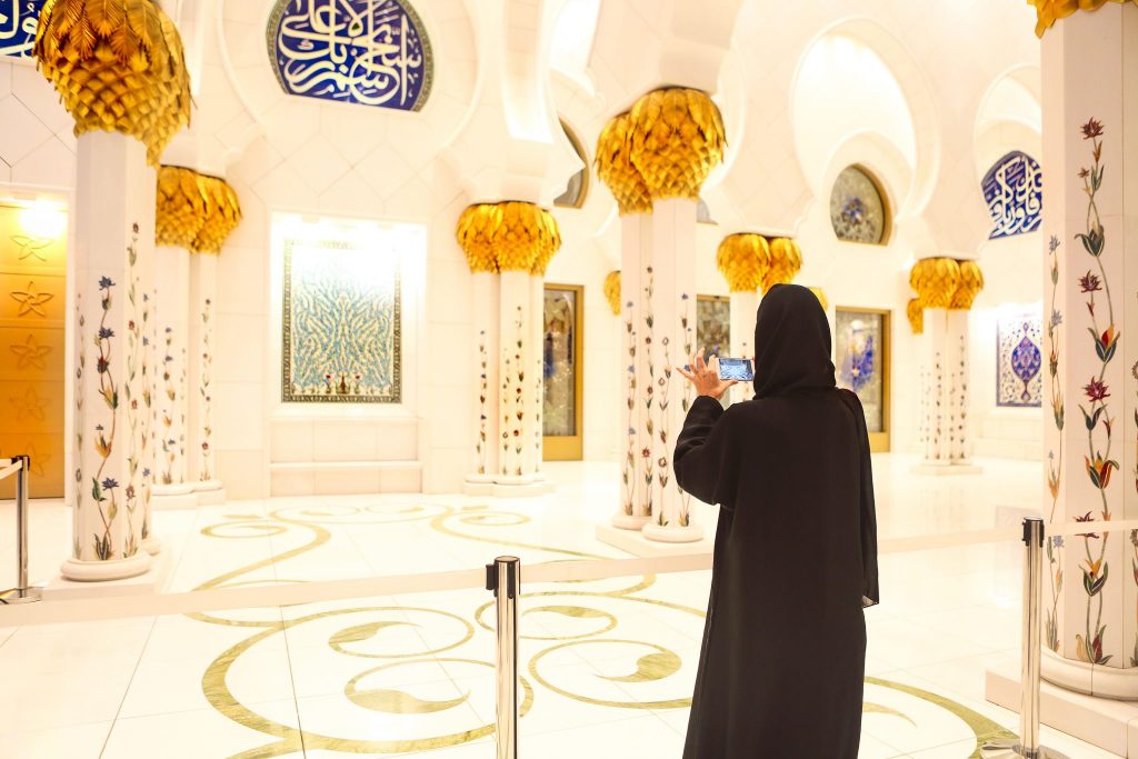 Woman taking picture of Sheikh Zayed Grand Mosque