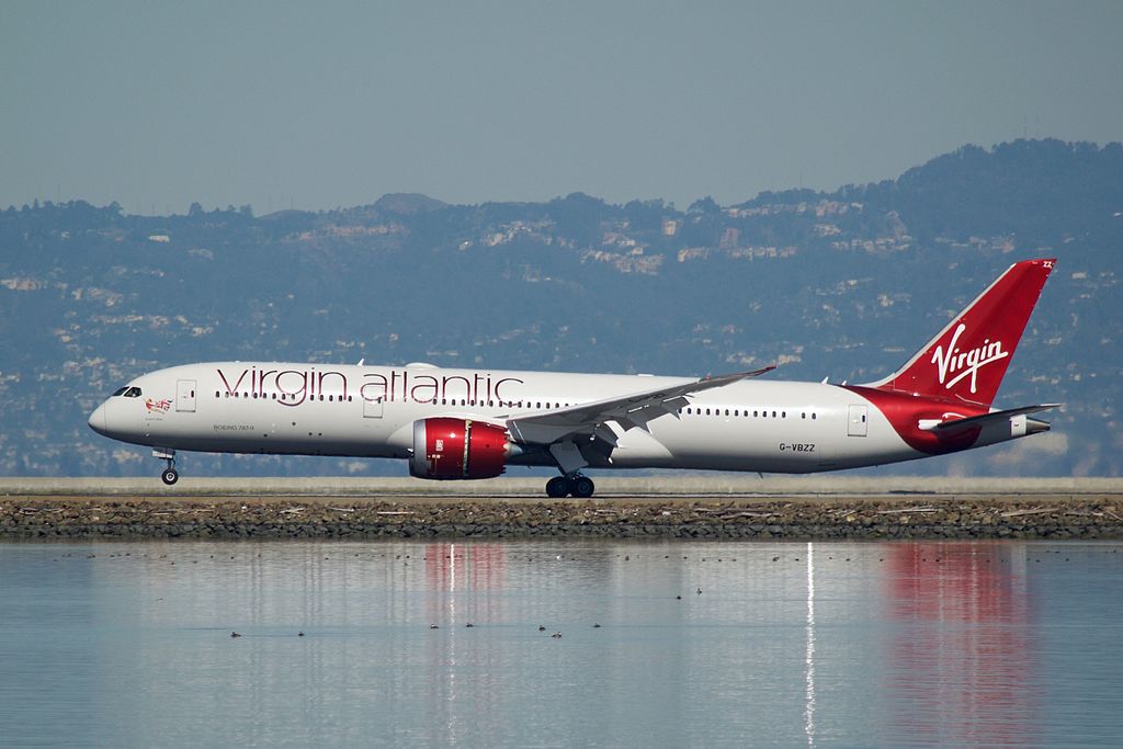 Virgin Atlantic Boeing 787 Dreamliner flying over water.
