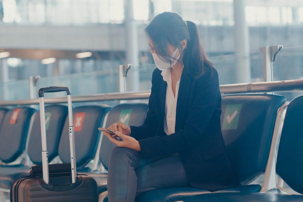 Woman checking her flight reservation on her phone.