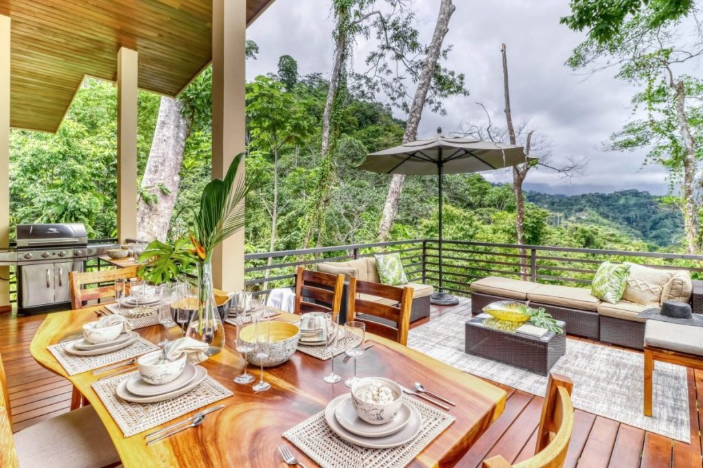 A table with dishes on a vacation rental deck.