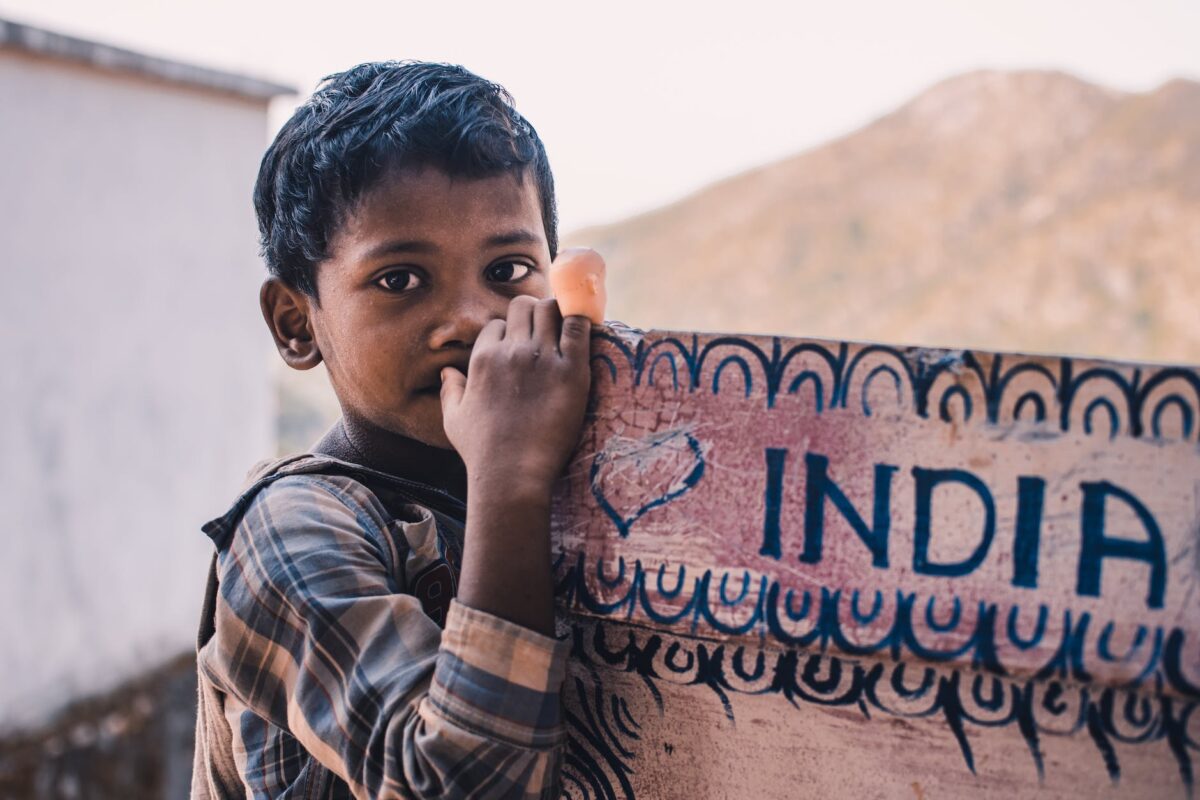 close up photography of a boy near a signboard