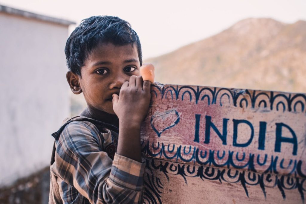 close up photography of a boy near a signboard