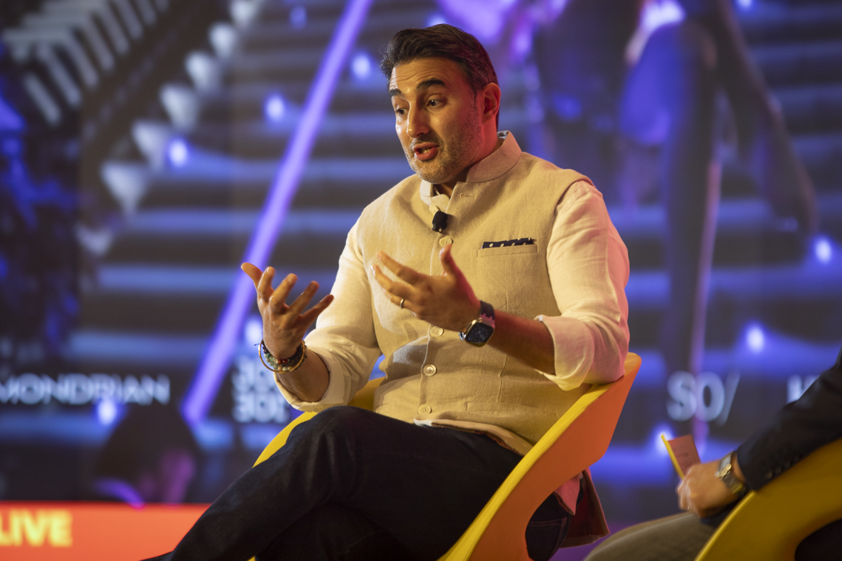 a hotelier talks on a stage