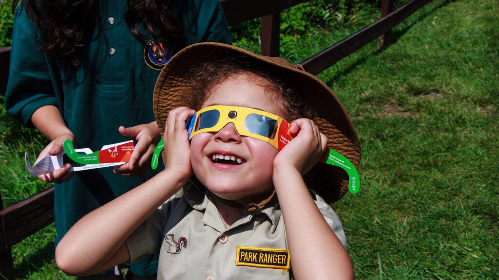 girl watching solar eclipse in 2018 George Garbeck Paterson Public Schools national park service