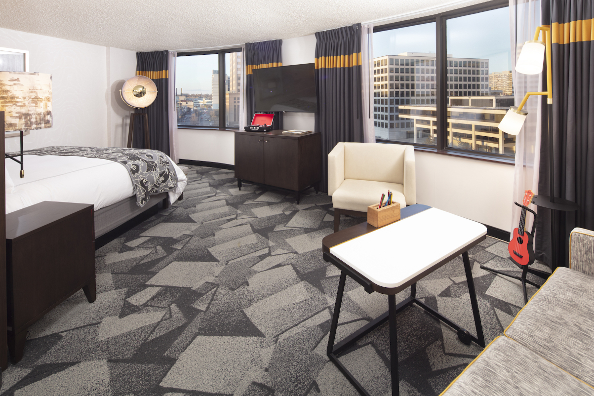 a corner king room with artworks on the wall at the st kate hotel in milwaukee wisconsin source saint kate arts hotel