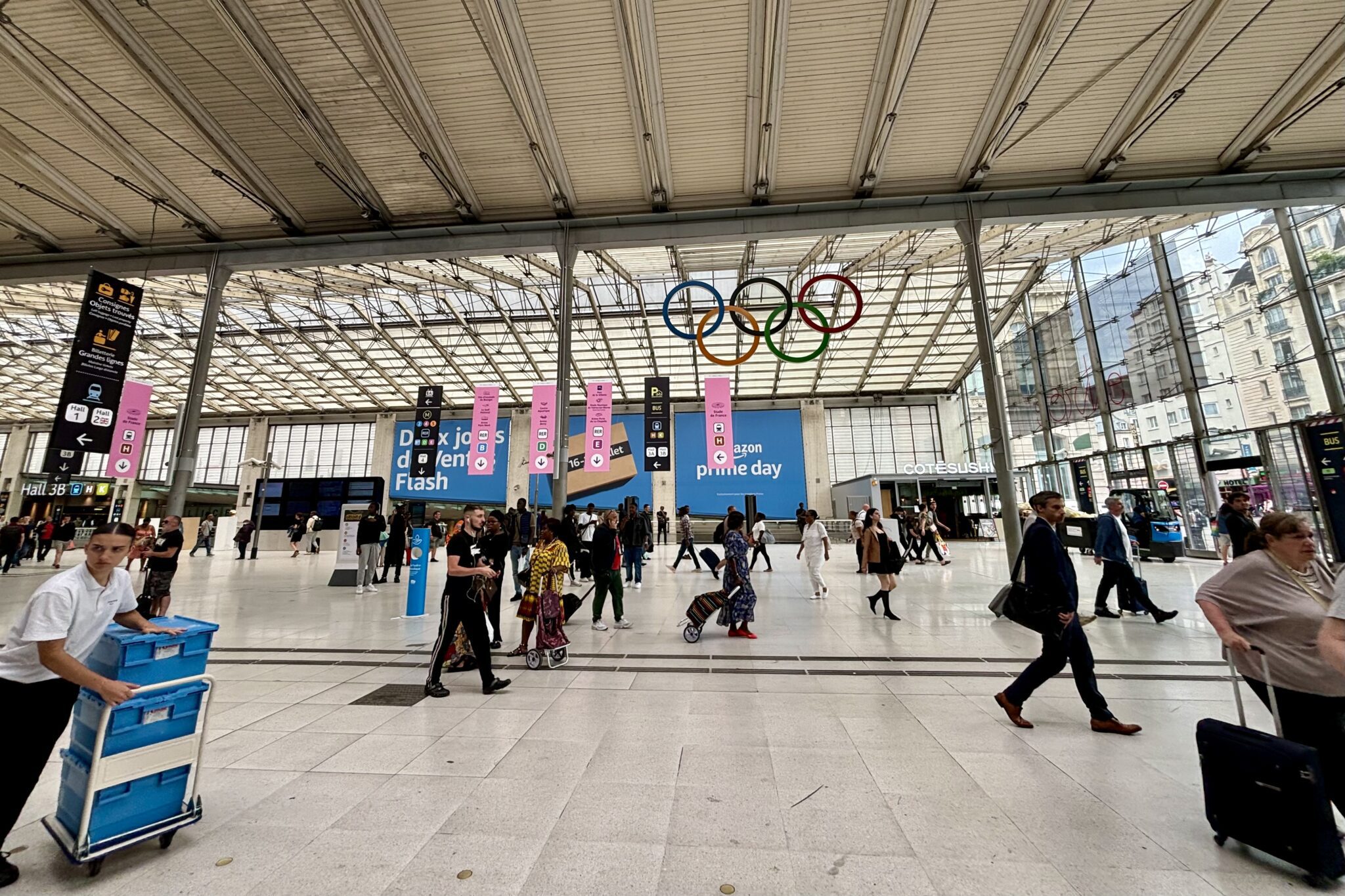 Interior of a train station with people walking back and forth