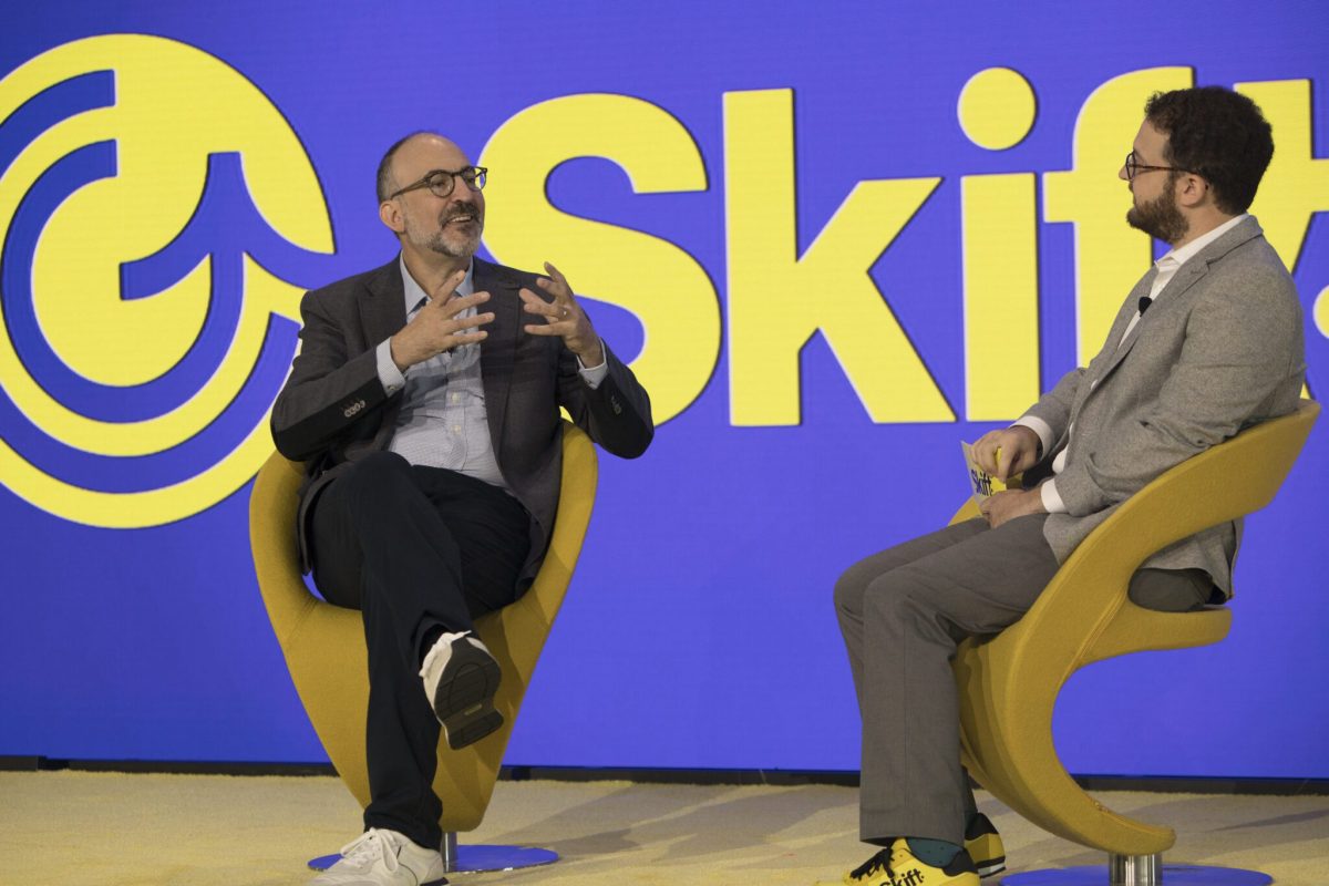 Tripadvisor's Matt Goldberg sitting in a chair on a stage being interviewed by Skift's Seth Borko.
