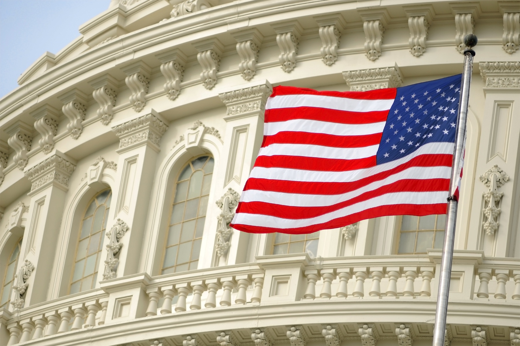 A flag flying next to the U.S. Capitol