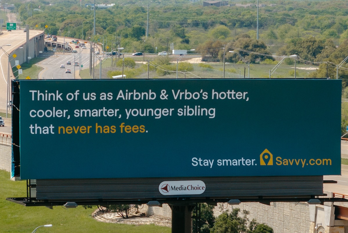 A billboard with a highway in the background in Austin, Texas.