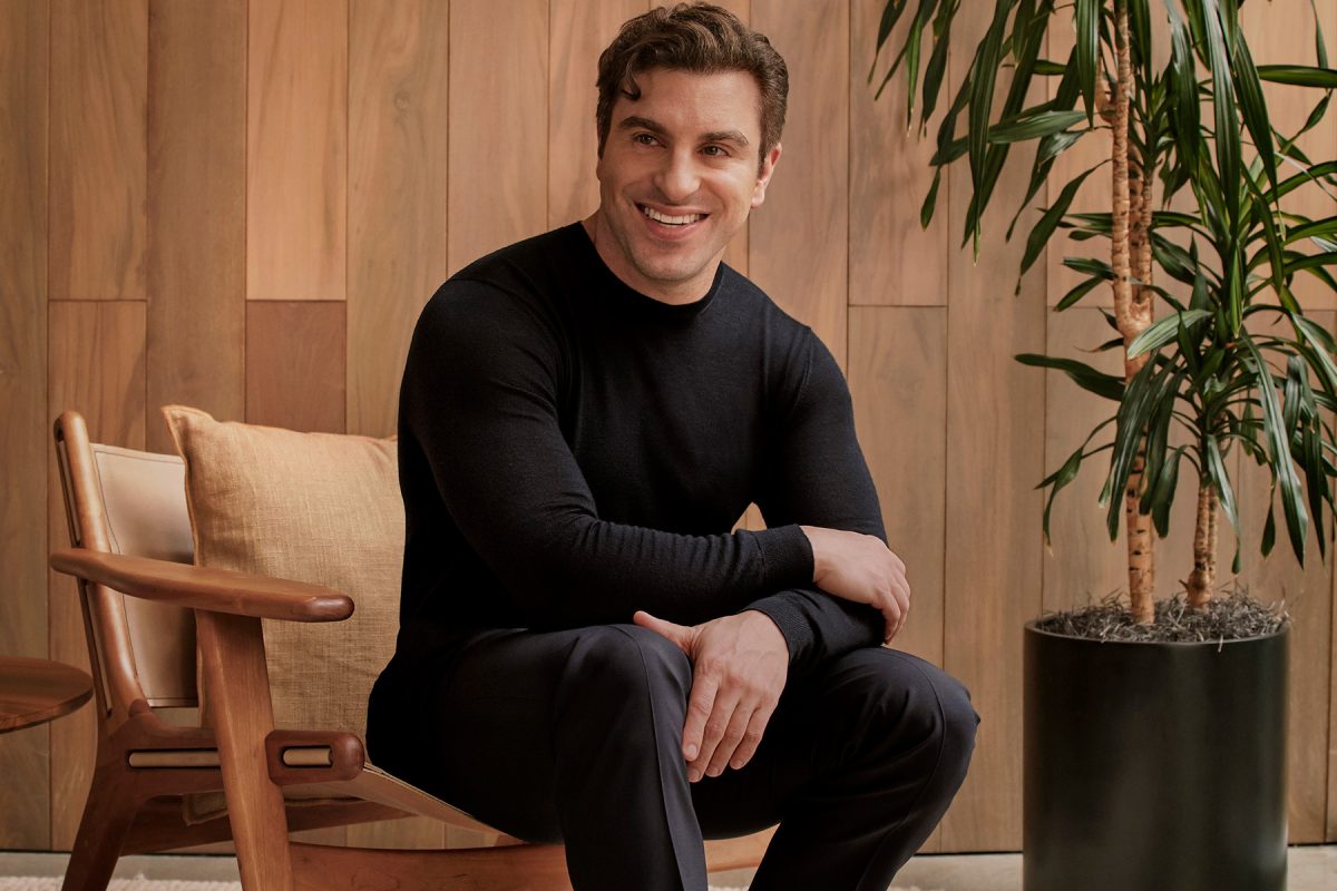 Portrait of a man dressed in black sitting on a chair