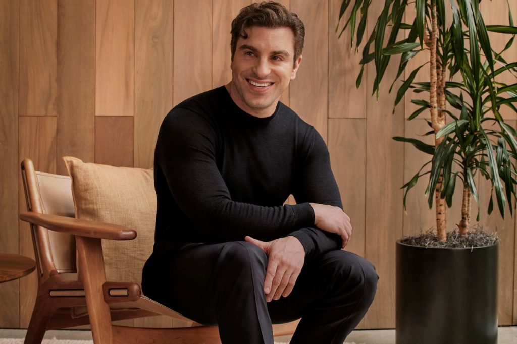 Portrait of a man dressed in black sitting on a chair