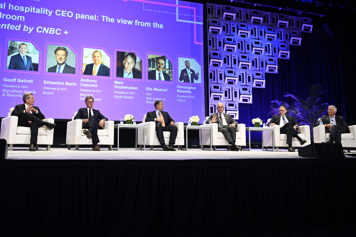 a panel of hotel ceos on a stage