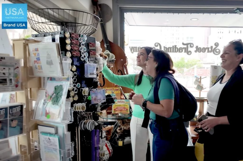 People looking at souvenirs in a shop.