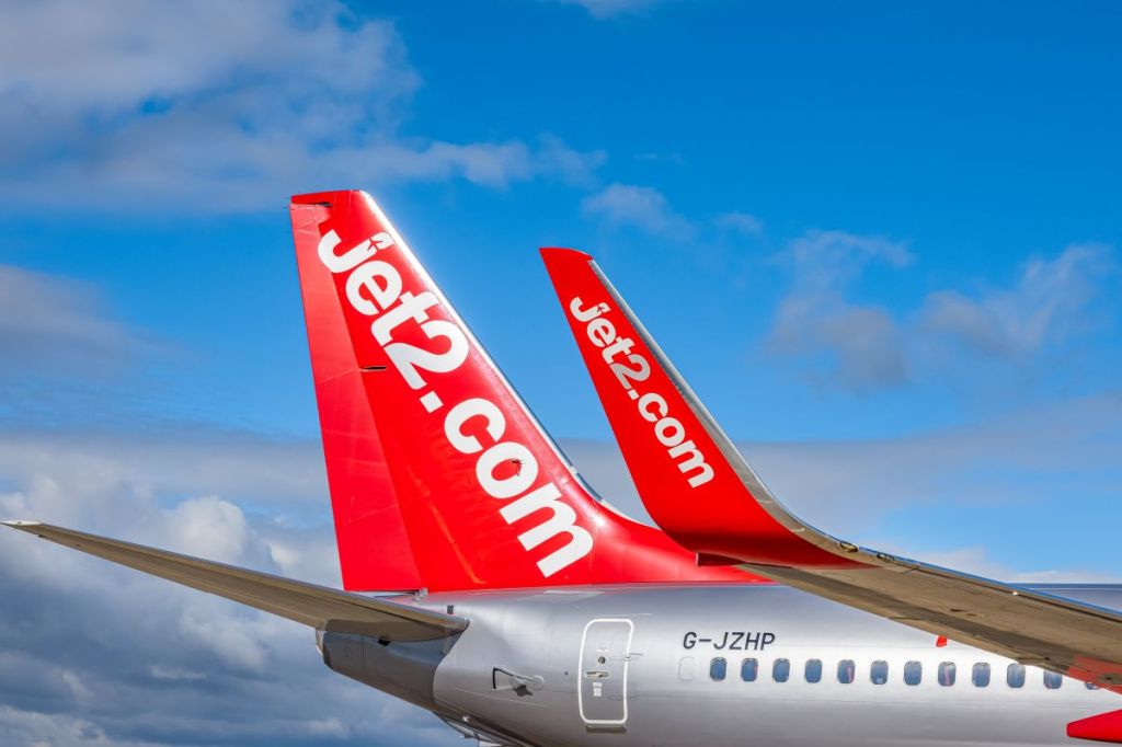 A Jet2.com aircraft against a blue sky.