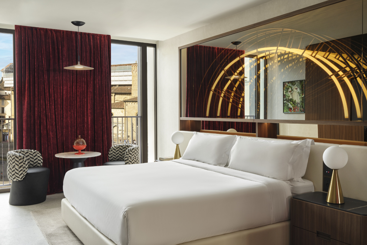 image of an upscale hotel room in Italy with a fancy bed