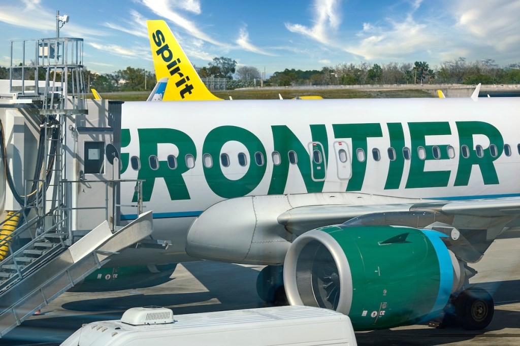 planes and equipment on a tarmac near airport gates.