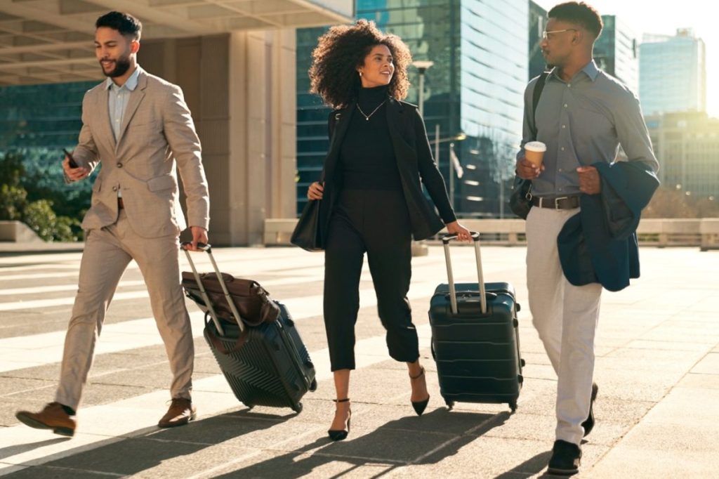 3 business travelers walking