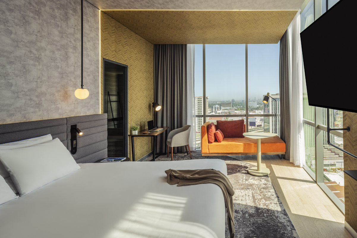 The view from the inside of a guest room at a Novotel hotel in Mexico City—it's bright and sunny with big windows.