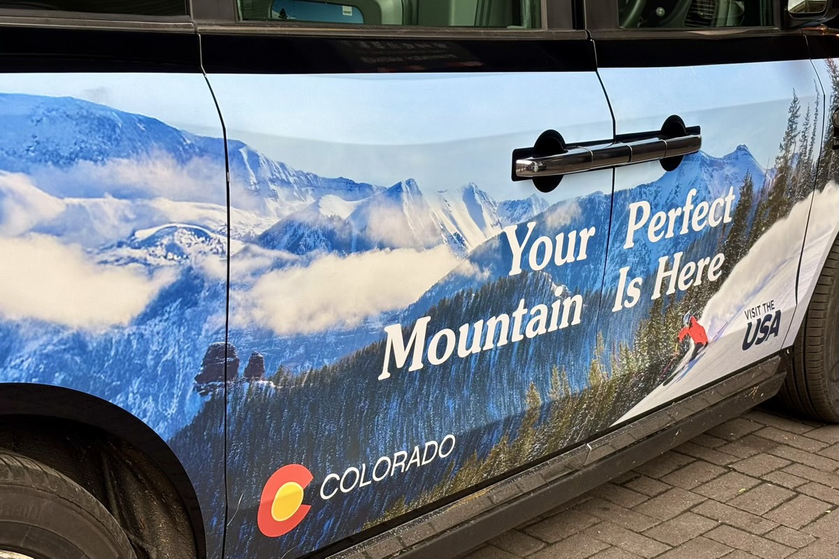 an advertisement on the side of a London black cab