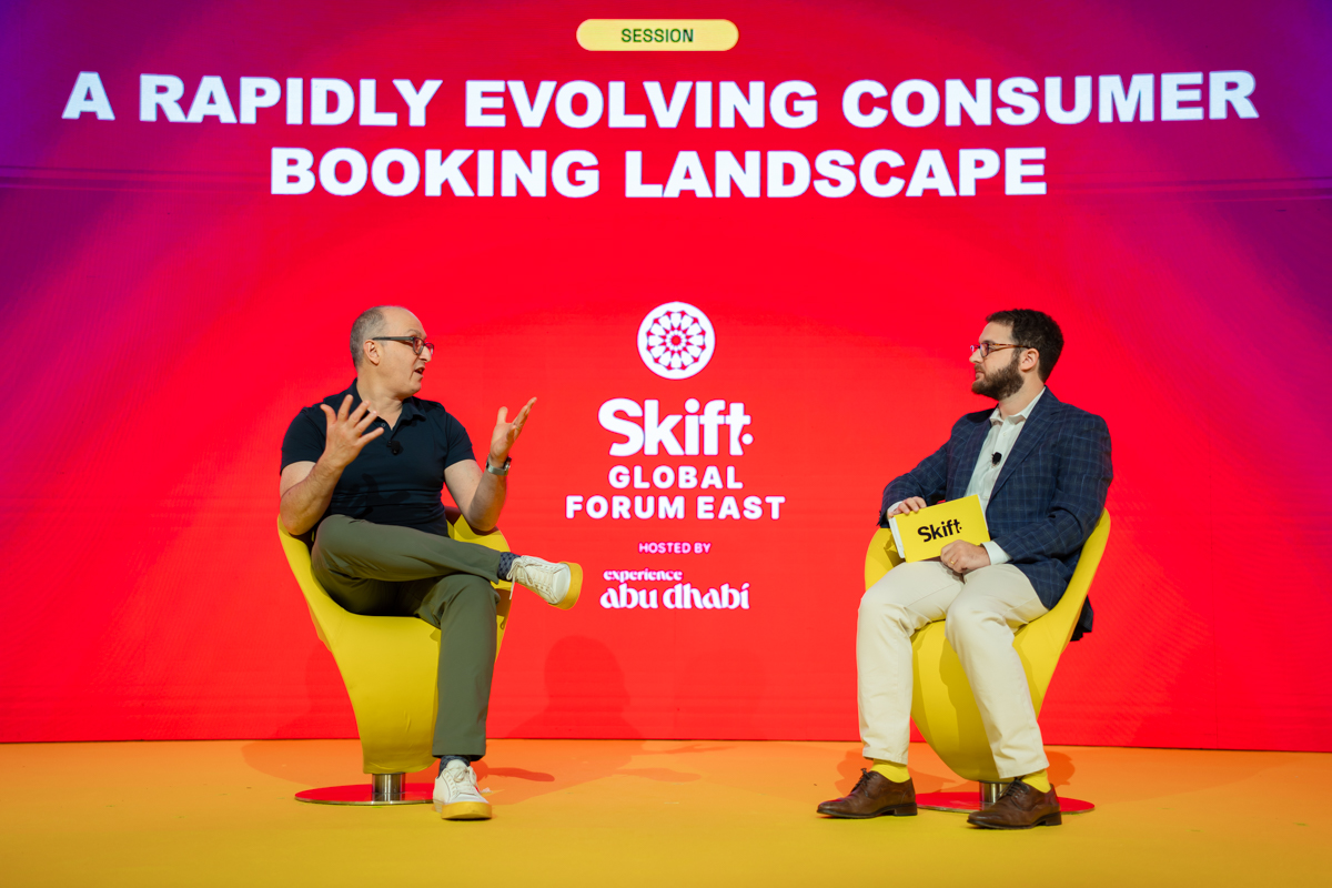 two men speaking on stage
