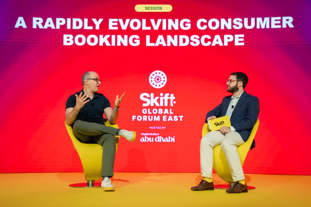 two men speaking on stage