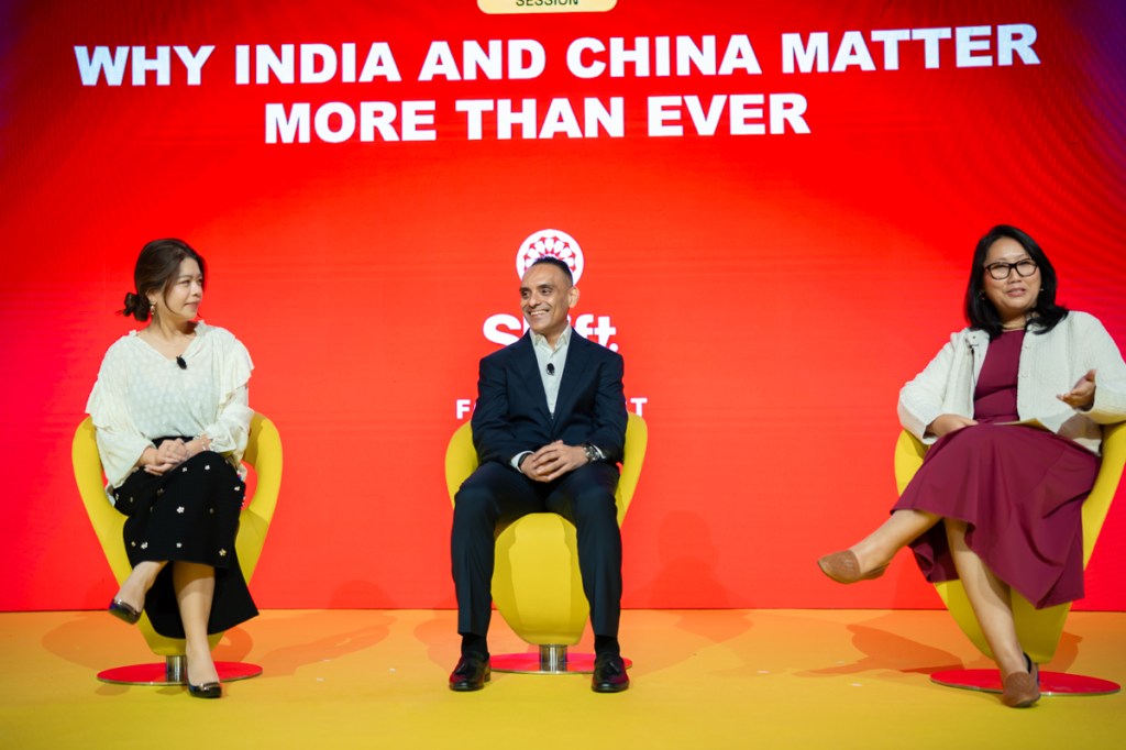 Three people in conversation on stage