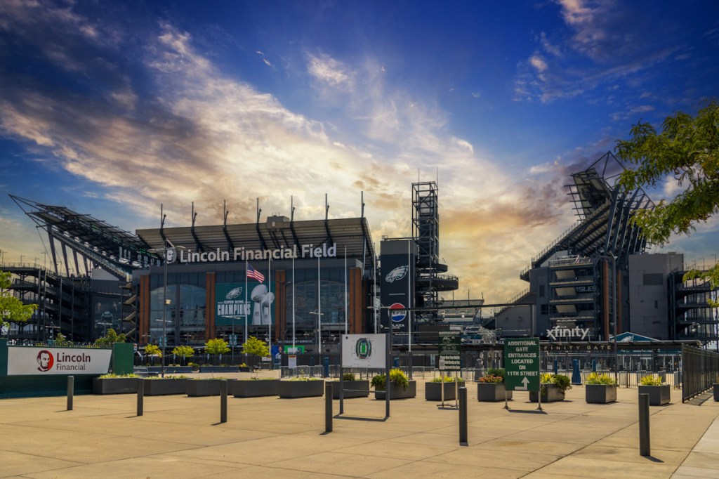 Exterior view of stadium grandstands under a blue sky