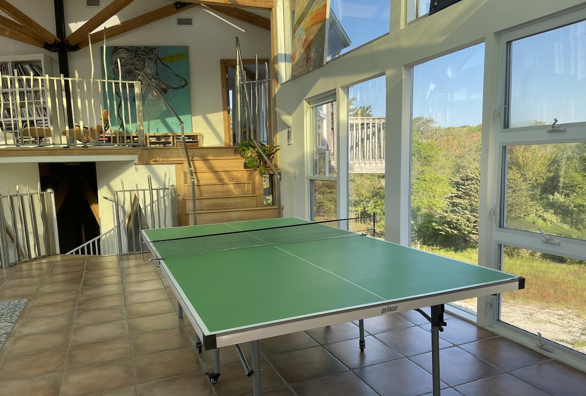 A vacation rental with a ping pong table in the foreground.