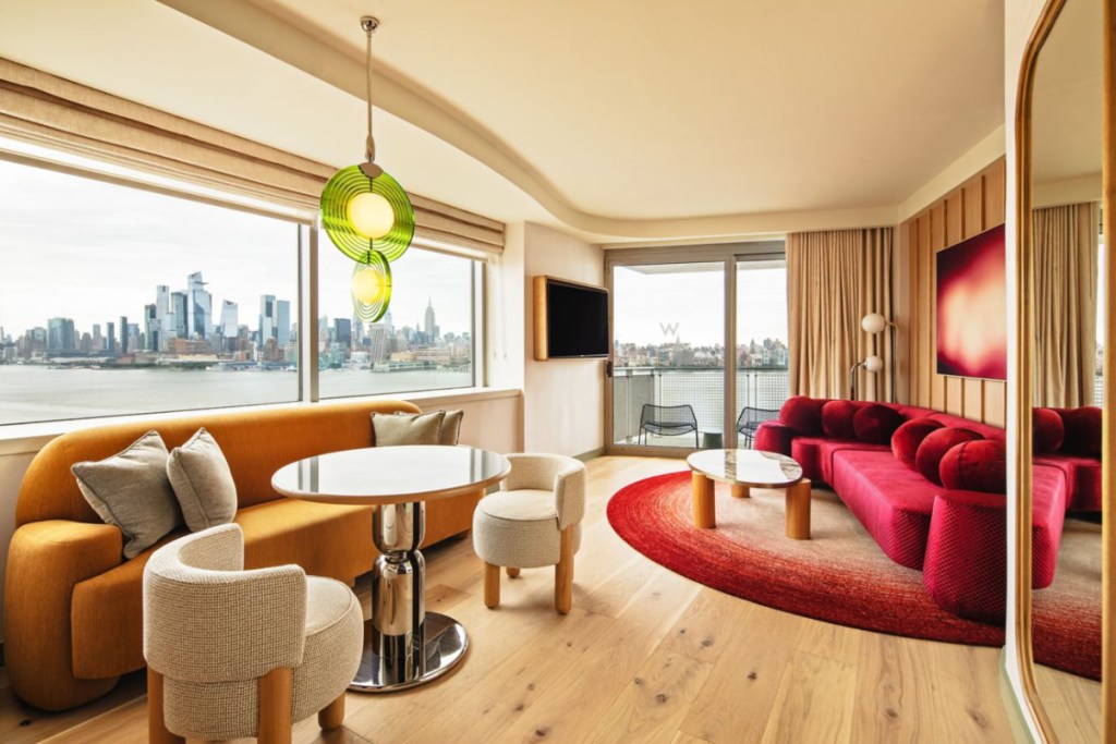 image of a guest room at W Hotel Hoboken with big windows and views of the Manhattan skyline