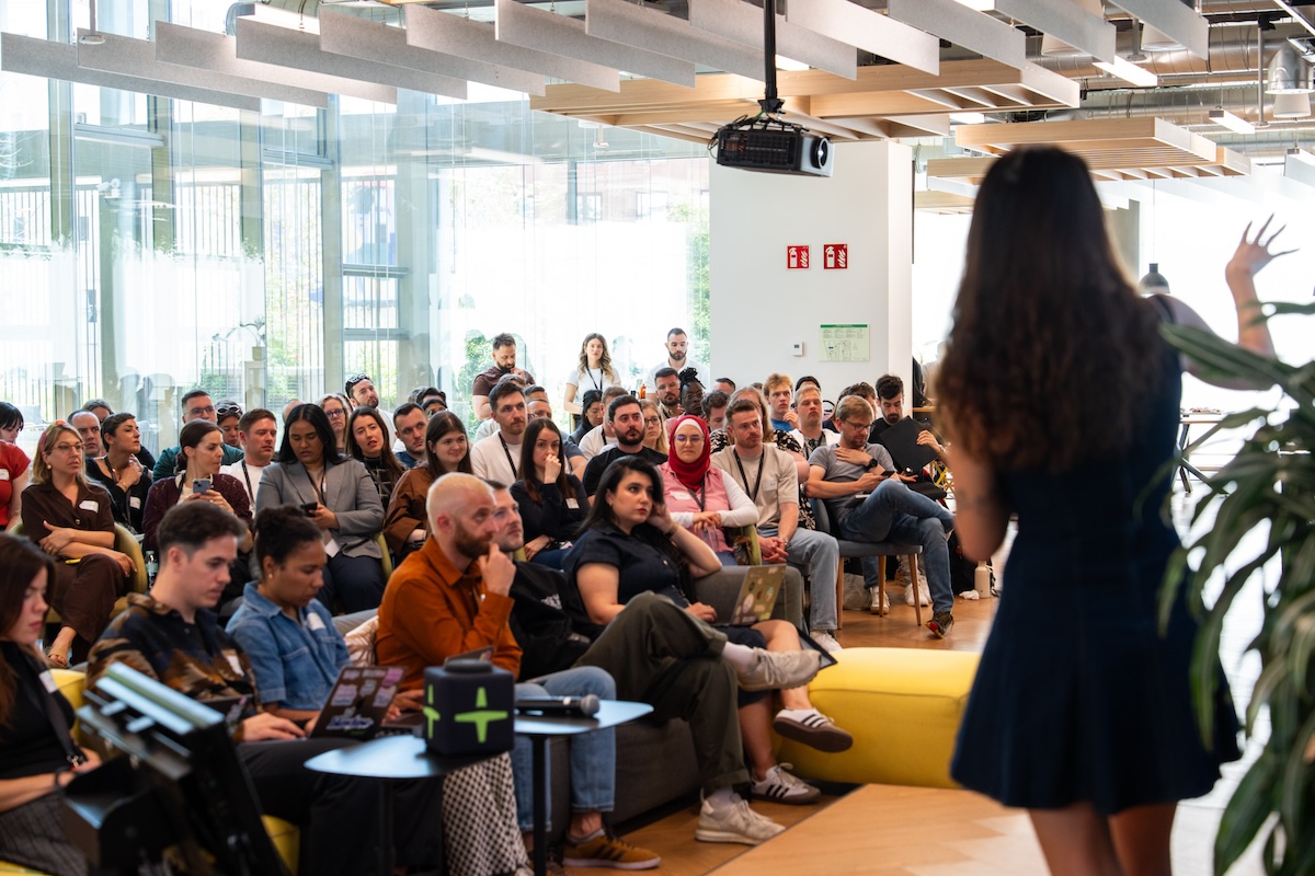 Employees in an office sitting on chairs in the audience and listening to a lecturer.