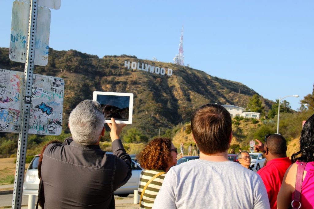 Tourists in California looking at the Hollywood sign.