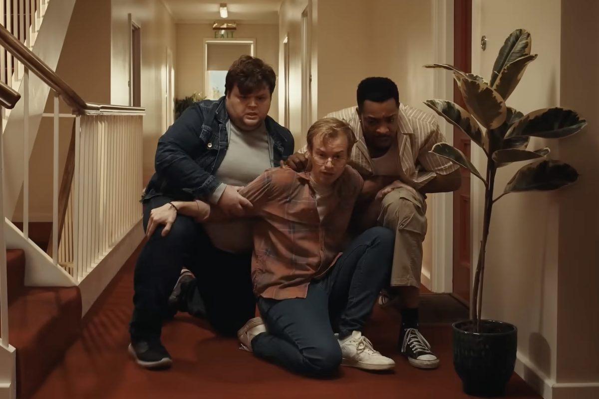 3 young people inside a home clutching one another and looking fearful in a humorous advertisement