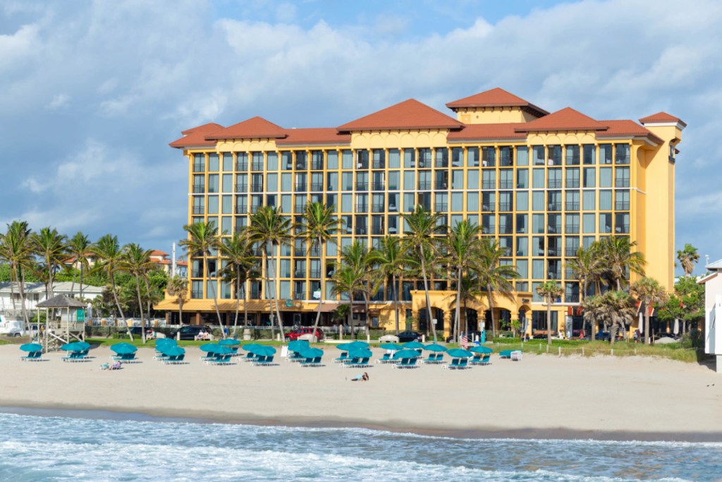 Image of a Florida resort from next year with chairs on the beach on a sunny day.
