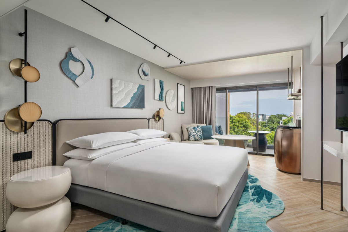 View of a family guest room at a Marriott resort in Thailand with a view through the window of a pretty resort on a sunny day