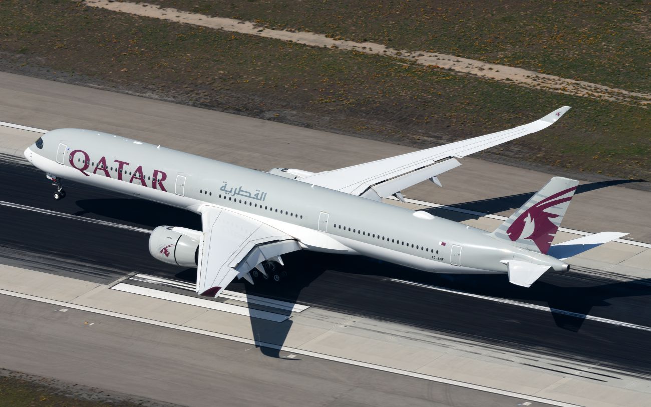 A Qatar Airways A350-1000 on the runway.