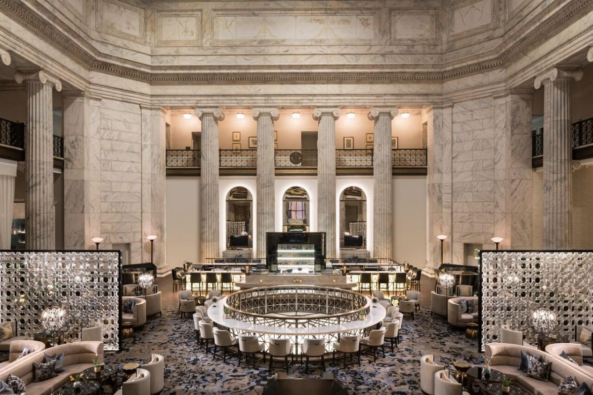 lobby of a luxury Ritz-Carlton hotel in Philadelphia with lots of marble columns and expensive furniture