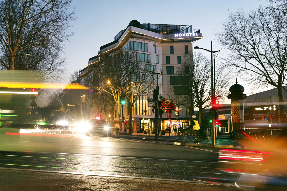 Exterior view of a Novotel at dusk.