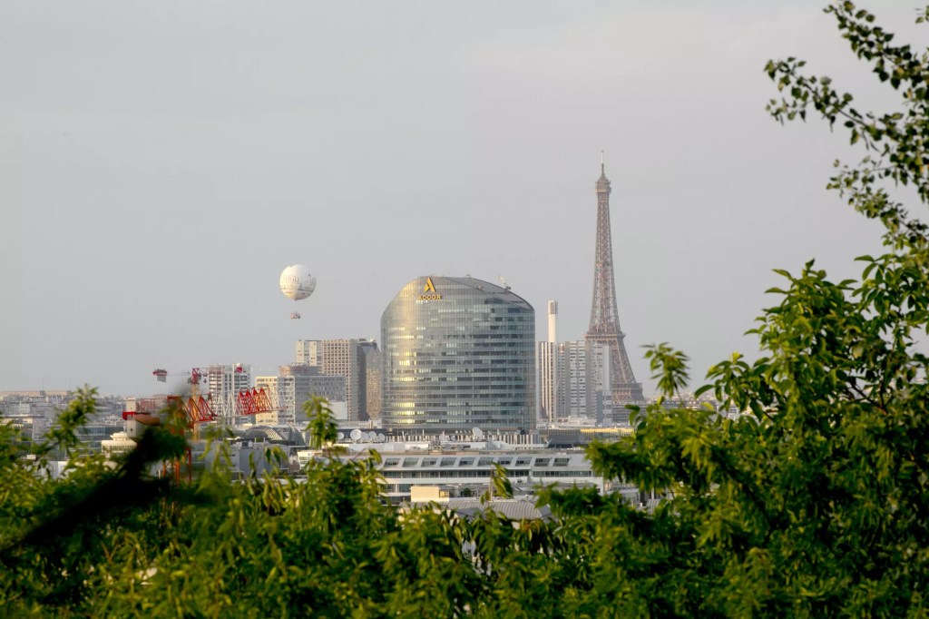 Image of the Paris skyline with Accor's headquarters in focus and the Eiffel Tower in the background.